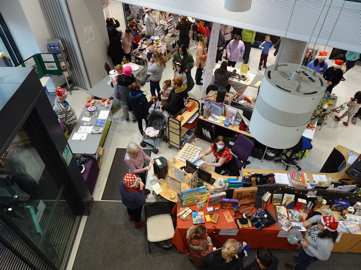 Reception area and TRA tombola stall, Clay Farm Centre Christmas Fair. Photo: Andrew Roberts, 9 December 2023.
