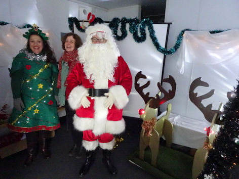 Father Christmas with Amanda Nilsson and Amanda Hawkes at the Trumpington Pavilion Christmas Fair. Photo: Andrew Roberts, 4 December 2022.